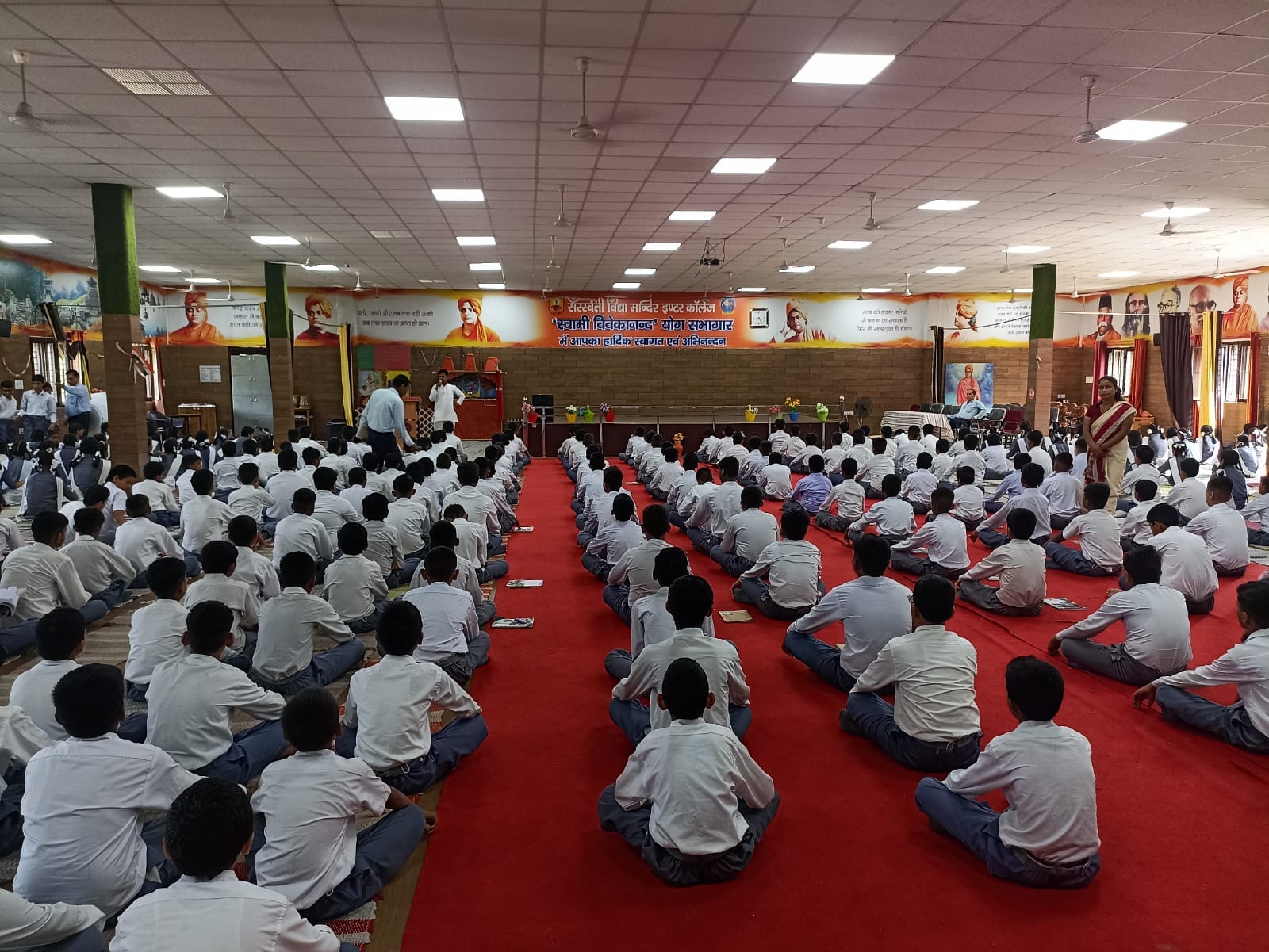 Students participating in a school assembly learning session
